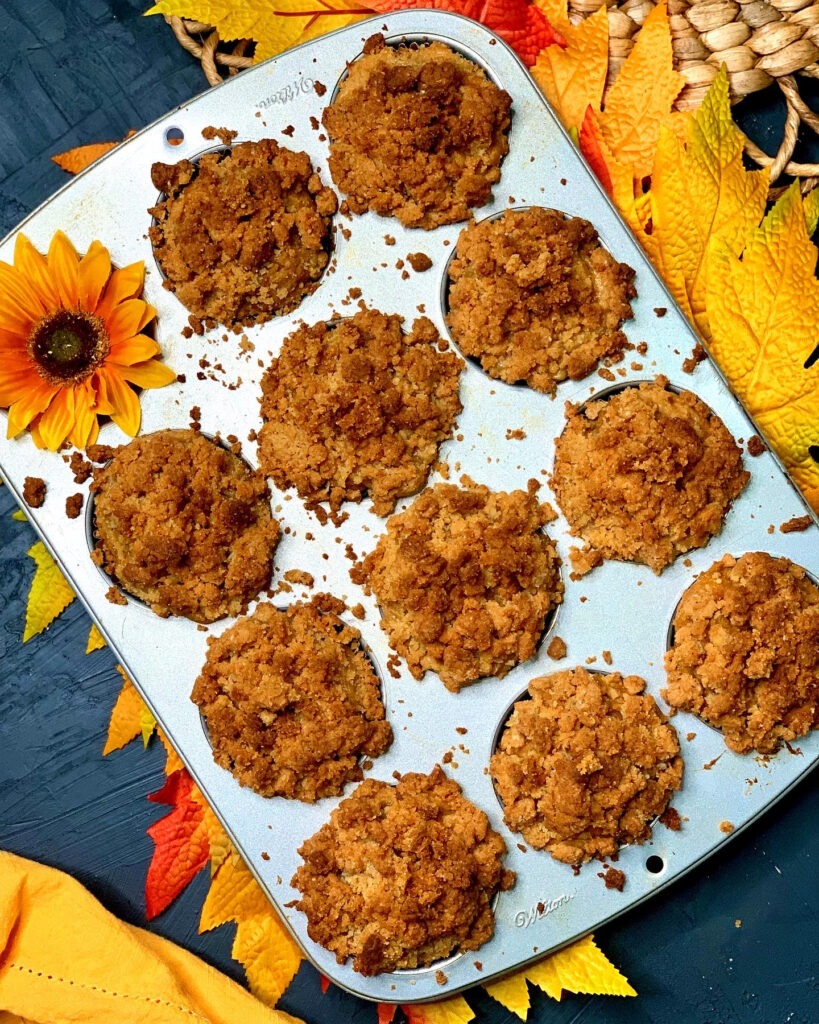 Muffin tin full of pumpkin cream cheese muffins