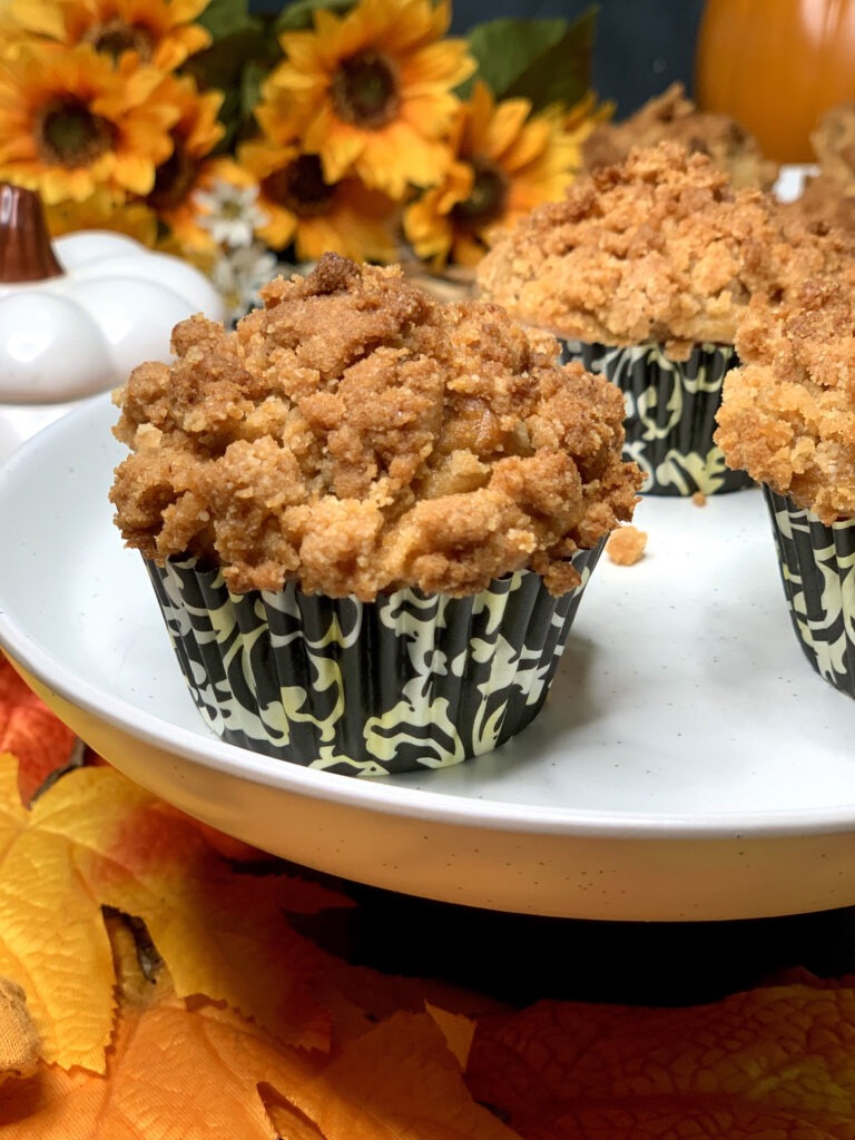 close up of pumpkin cream cheese muffin with streusel topping