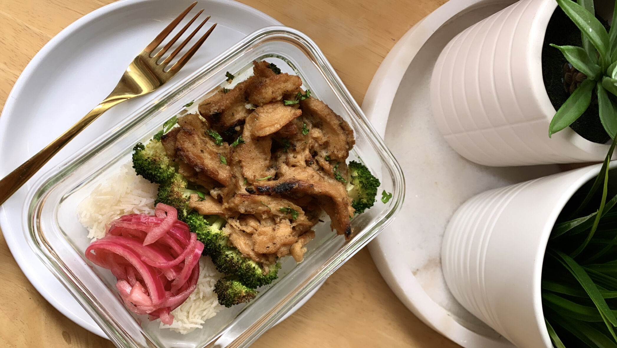 Meal prep container with coconut lime soy curls, broccoli, pickled red onion