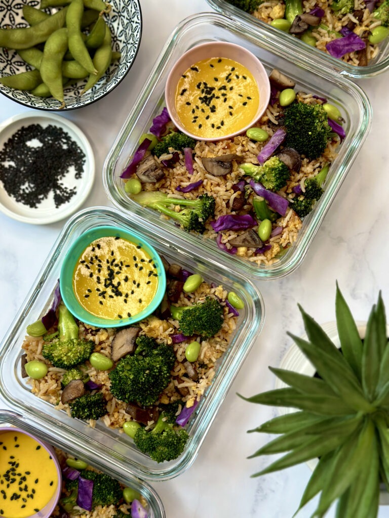 Veggie fried rice meal prep: containers with veggie friend rice. Side dish of miso-turmeric dressing