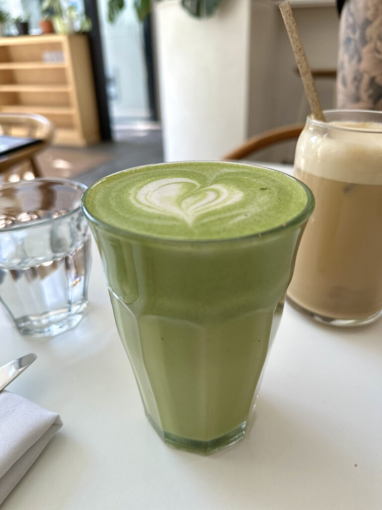 matcha latte with heart latte art in it