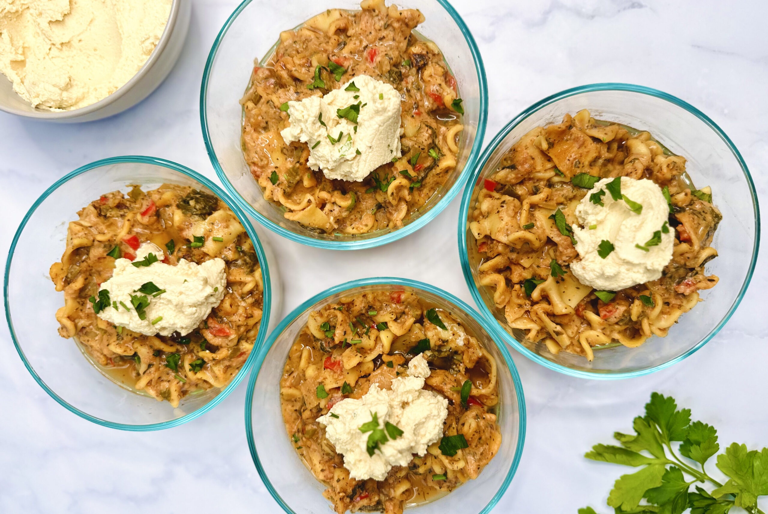 meal prep container with lasagna soup with tofu ricotta on top