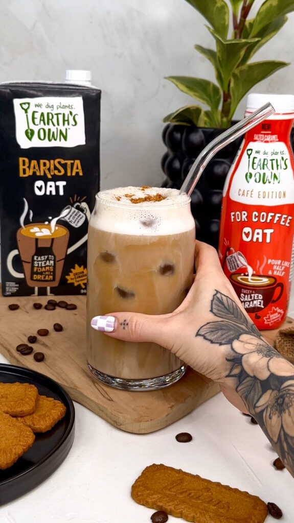 hand grabbing glass of salted caramel cookie butter latte