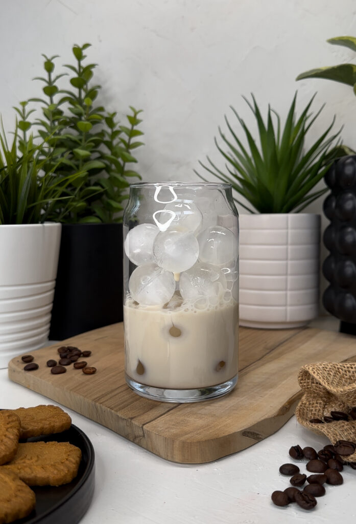 adding oat barista to a glass of ice