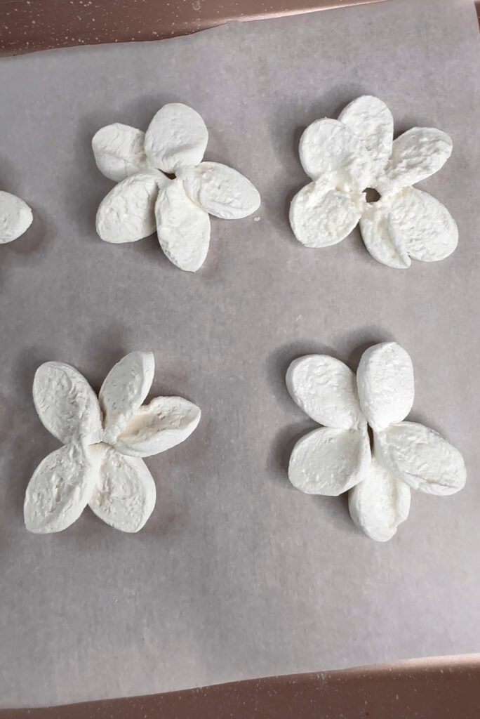 marshmallow flowers on a baking tray ready to be baked. 