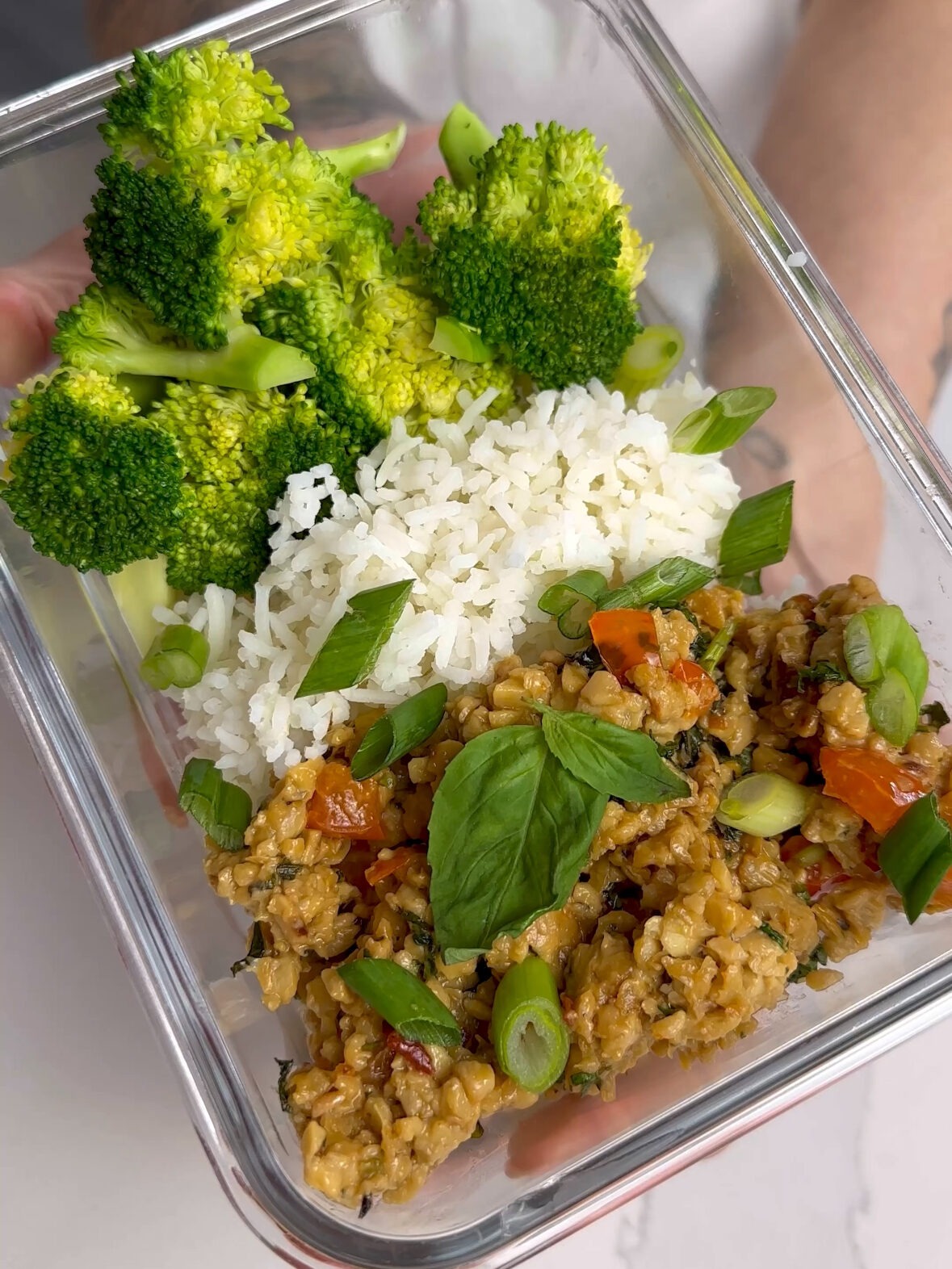 close up of basil tempeh meal prep container 