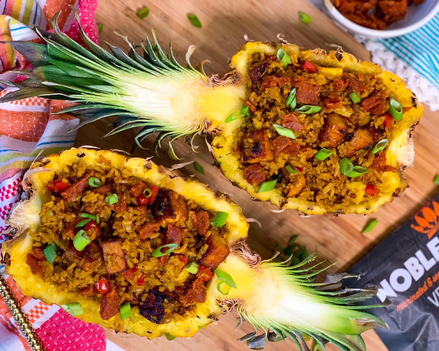 two pineapple bowls with sweet bbq fried rice