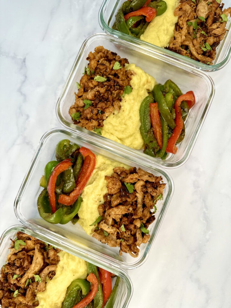 Cajun Chicken and Jalapeno-Corn Mash Meal Prep: containers with cajun chicken soy curls, green and red peppers, and jalapeno-corn mash.