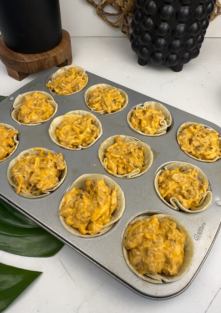 vegan buffalo chick'n bites mixture in muffin tin