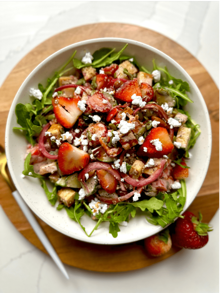 plate of strawberry poppyseed salad jar with feta crumble and balsamic glaze.