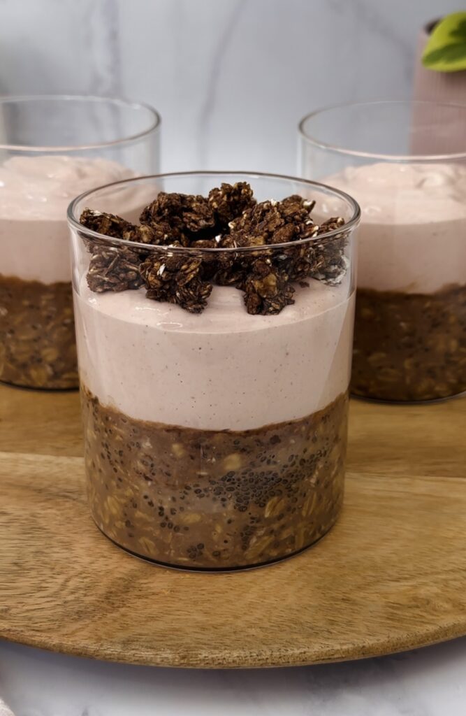 layered breakfast jar with chocolate oats on the bottom, and strawberry yogurt with me. 