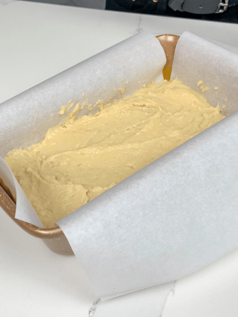 adding a layer of coffee cake batter to the loaf pan