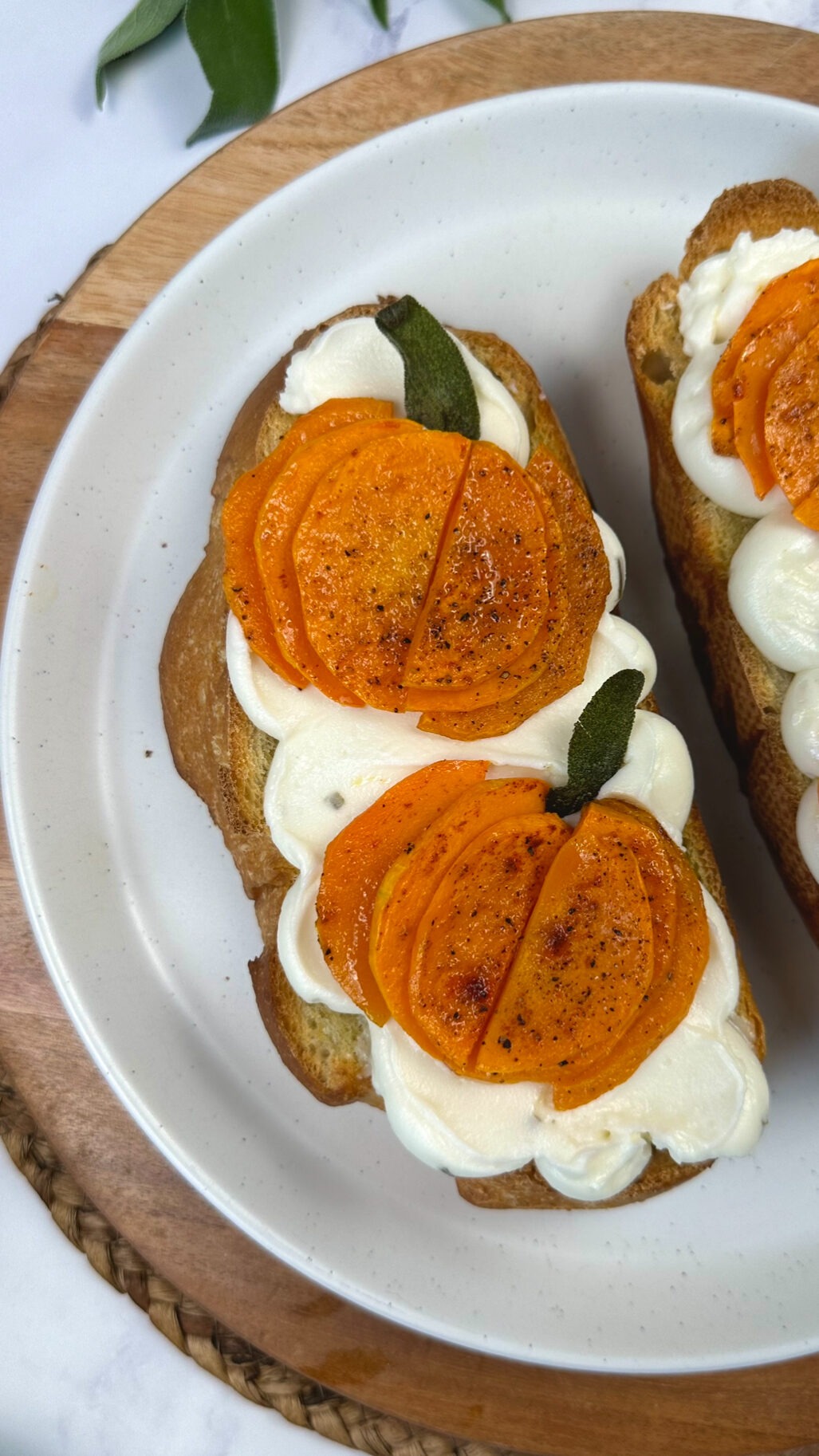 second picture of cream cheese toast with roasted butternut squash pumpkins with sage leaf stems on top