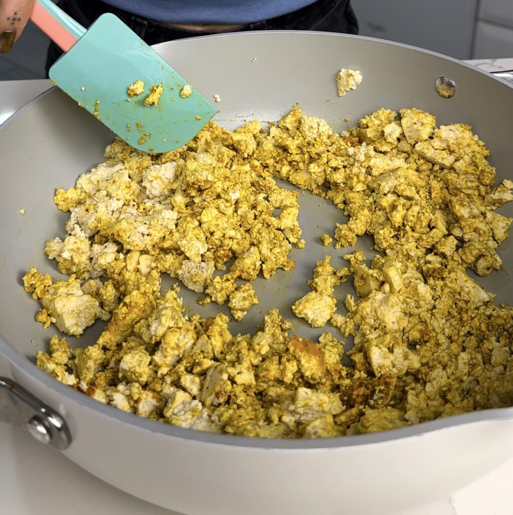 tofu scramble in pan with seasoning