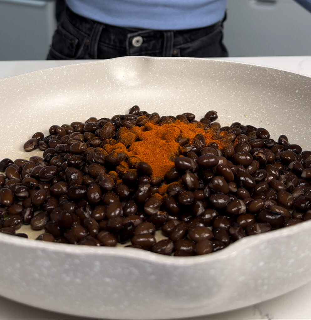 pan of black beans and seasoning 