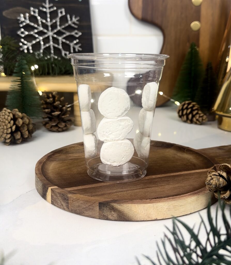 add three marshmallow circles stacked on top of eachother making a snowman