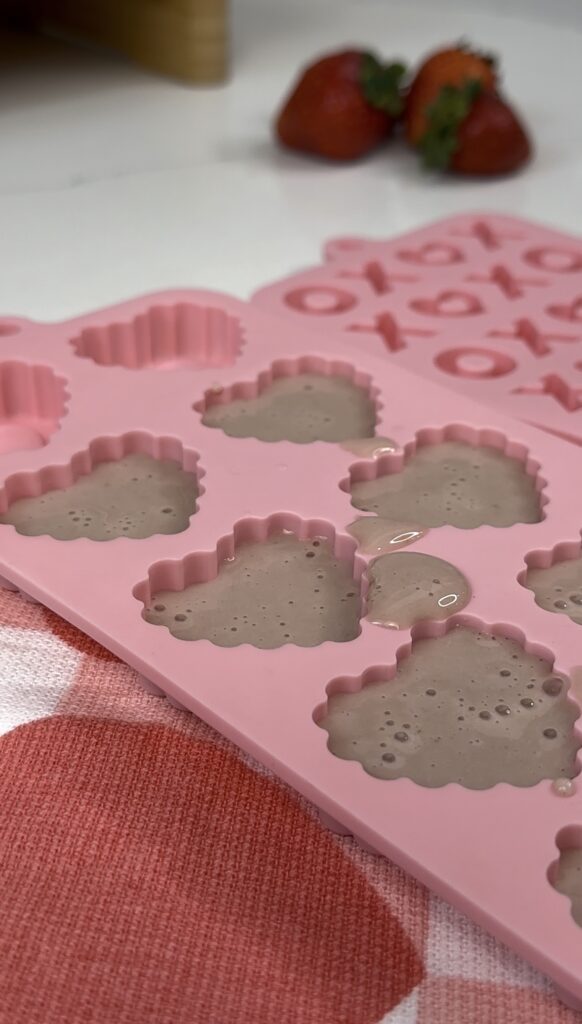 Filling silicone mold with non-dairy strawberry milk