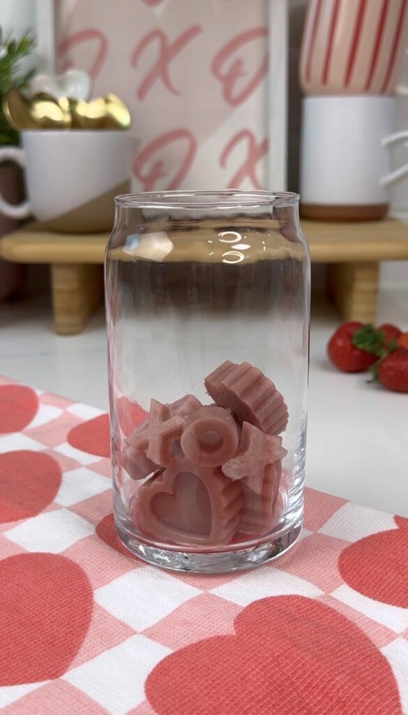 heart and xox strawberry ice cubes in glass cup