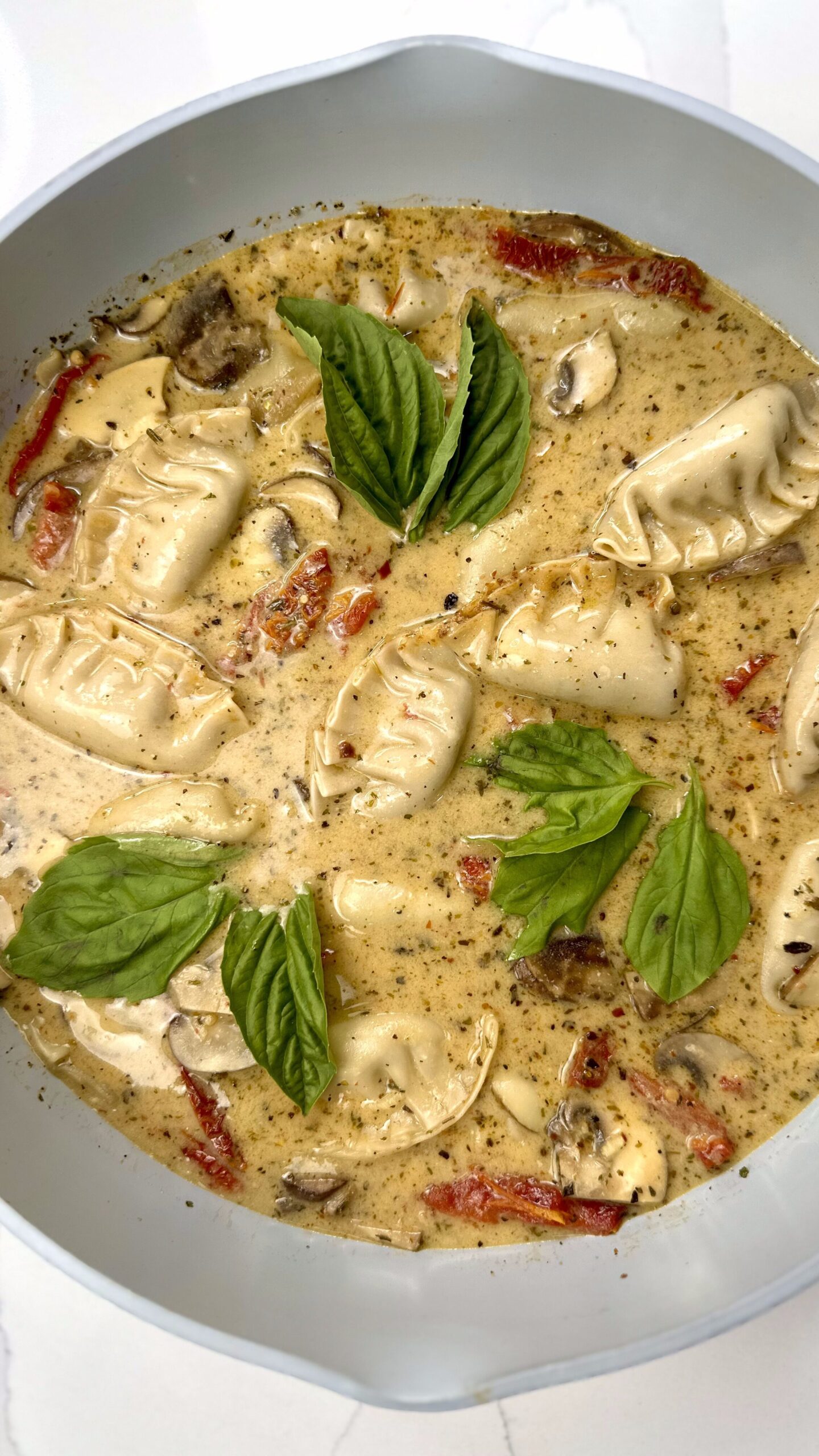 Skillet with Marry Me Dumplings (dumplings resting in creamy sundried tomato sauce)