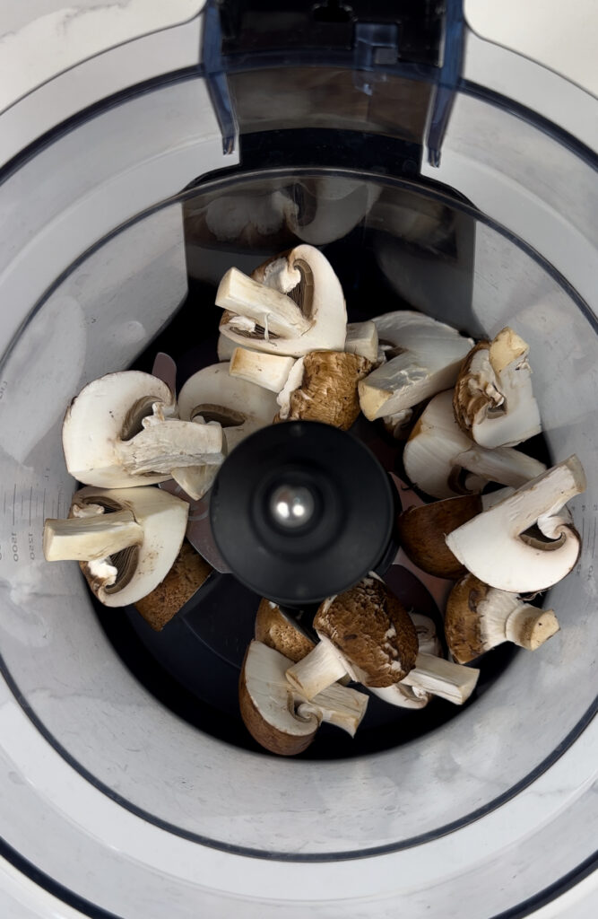 food processor with mushrooms added 