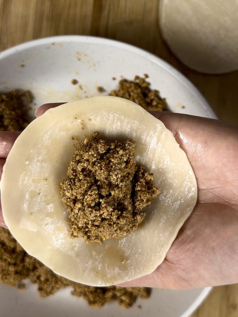 dumpling wrapper with tofu-mushroom mixture dollop in center