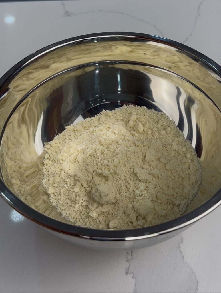 adding almond flour to a mixing bowl for the shortcake crumble