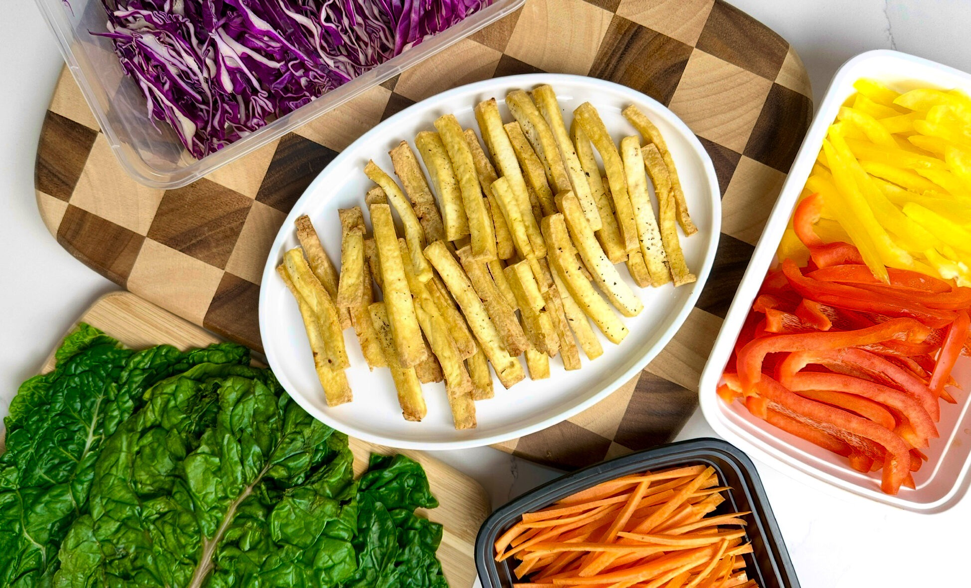 display of the crispy tofu, sliced bell peppers, shredded purple cabbage, carrot sticks and swiss chard