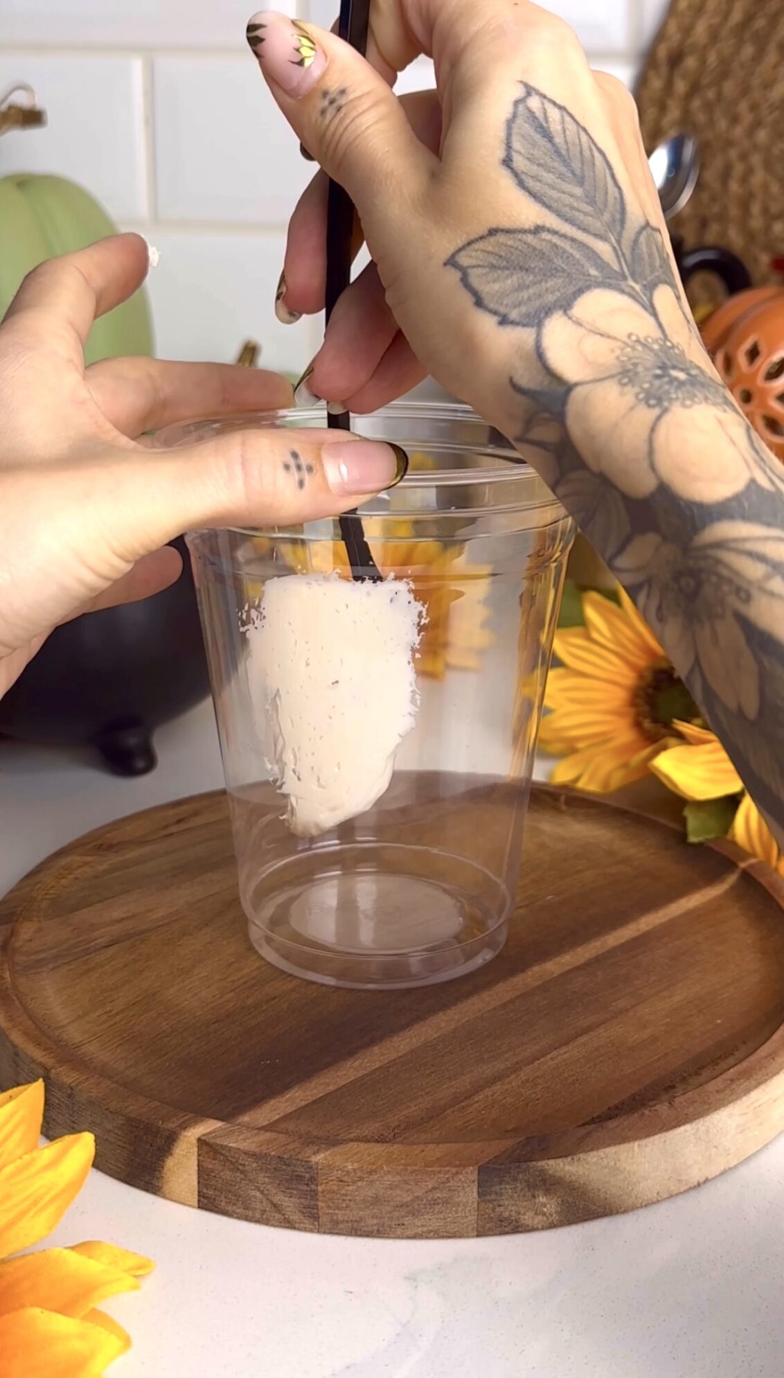Marshmallow ghost being added to a cup