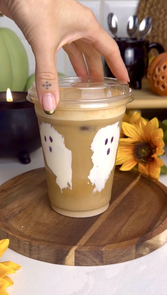 cup with marshmallow ghosts filled with a toasted marshmallow latte with pumpkin cold foam.