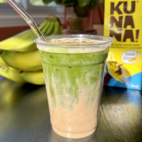 ice in cup with banana milk with matcha layer on top.