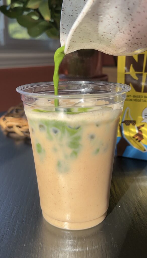 matcha being poured over ice and banana bread milk