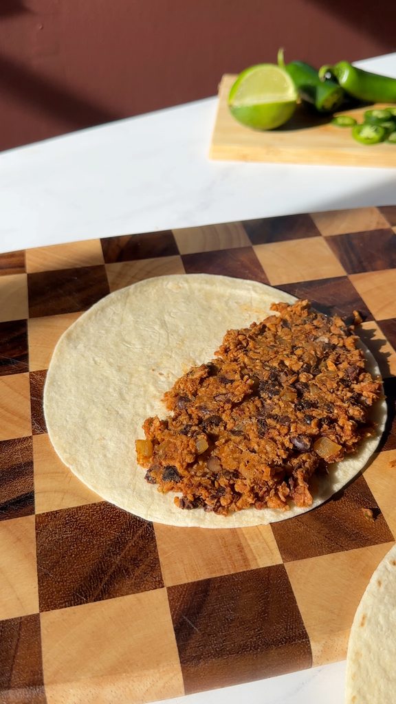 Black bean & TVP mixture added to half of each tortilla.