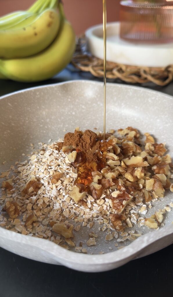 drizzling maple syrup over cinnamon, nutmeg, walnuts, and oatmeal.