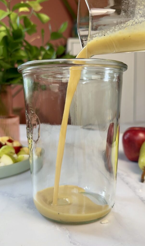 Weck glass canning jar with maple dijon dressing being poured in.